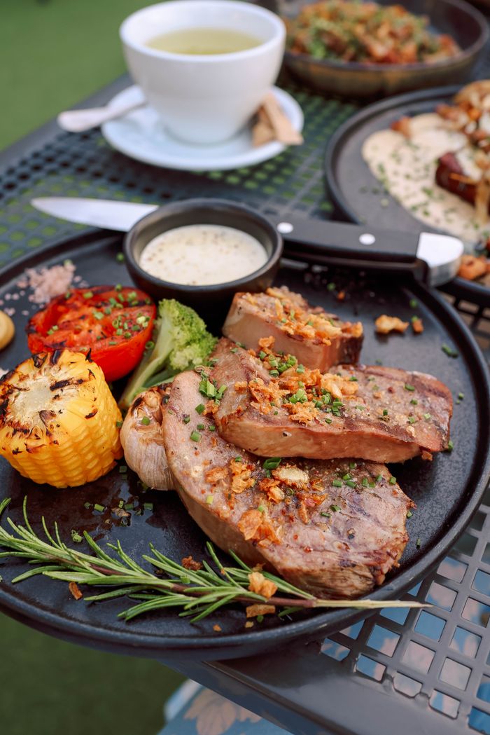 Crafting Captivating Headlines: Your awesome post title goes here Delicious grilled steak dinner plate with vegetables, served outdoors on a sunny day.